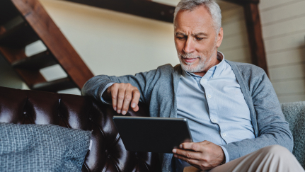 man looking at a tablet