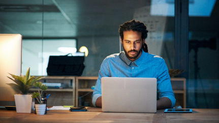 man looking at a laptop
