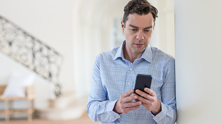 man looking at a mobile phone